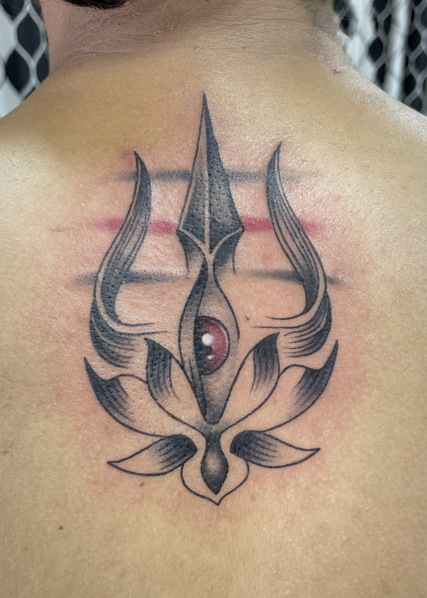 trishul wiht eye and lotus tattoo