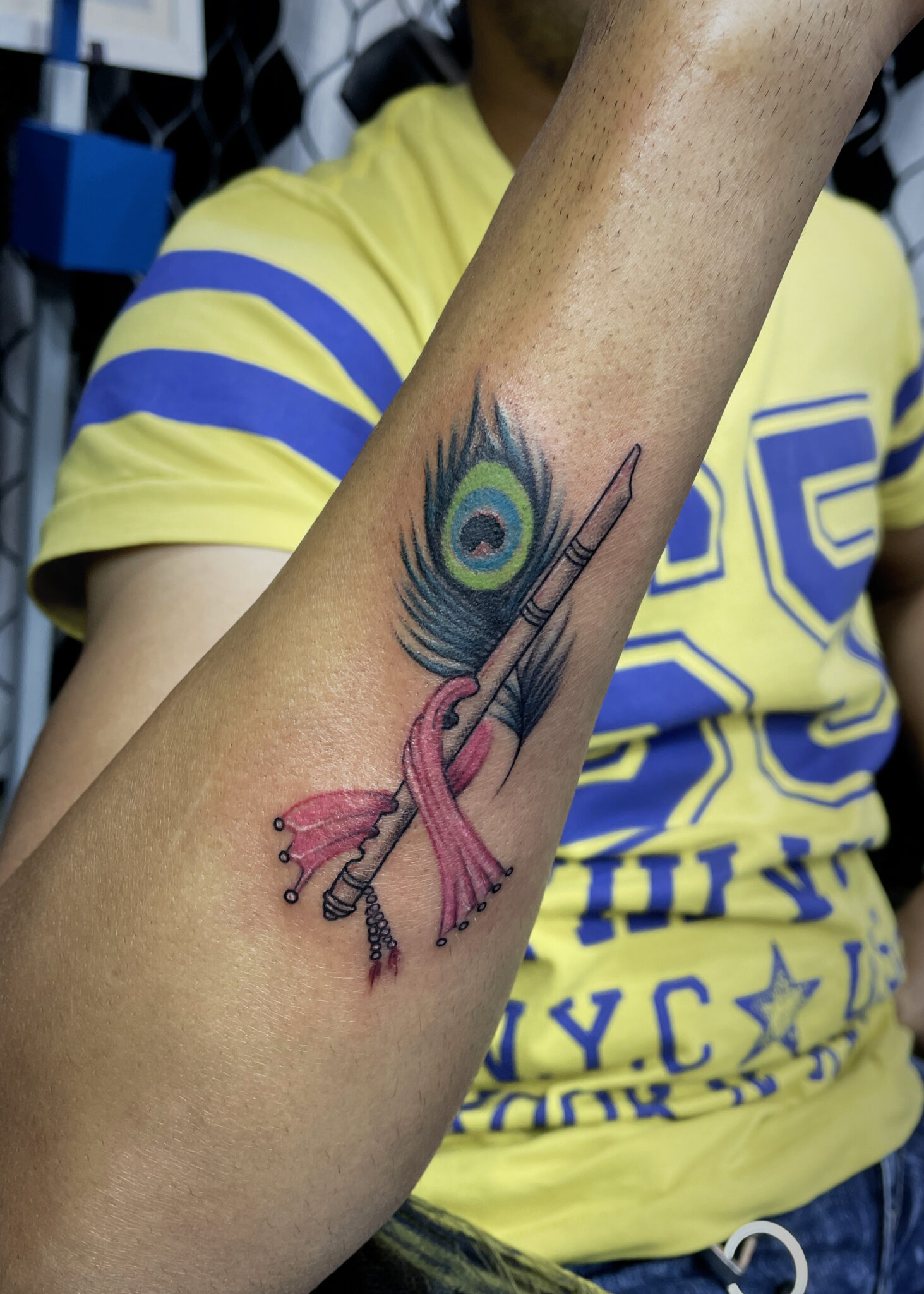 peacock feather with flute tattoo